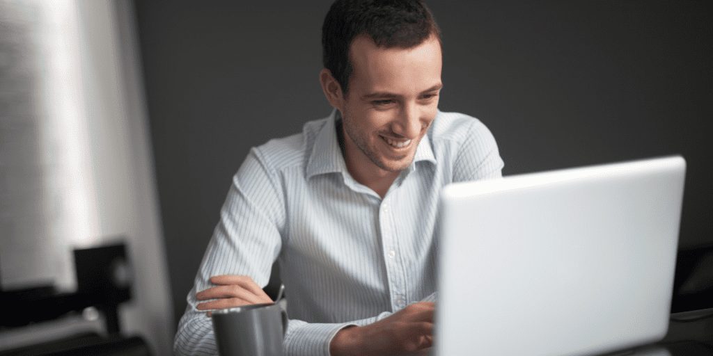 Man smiling on computer